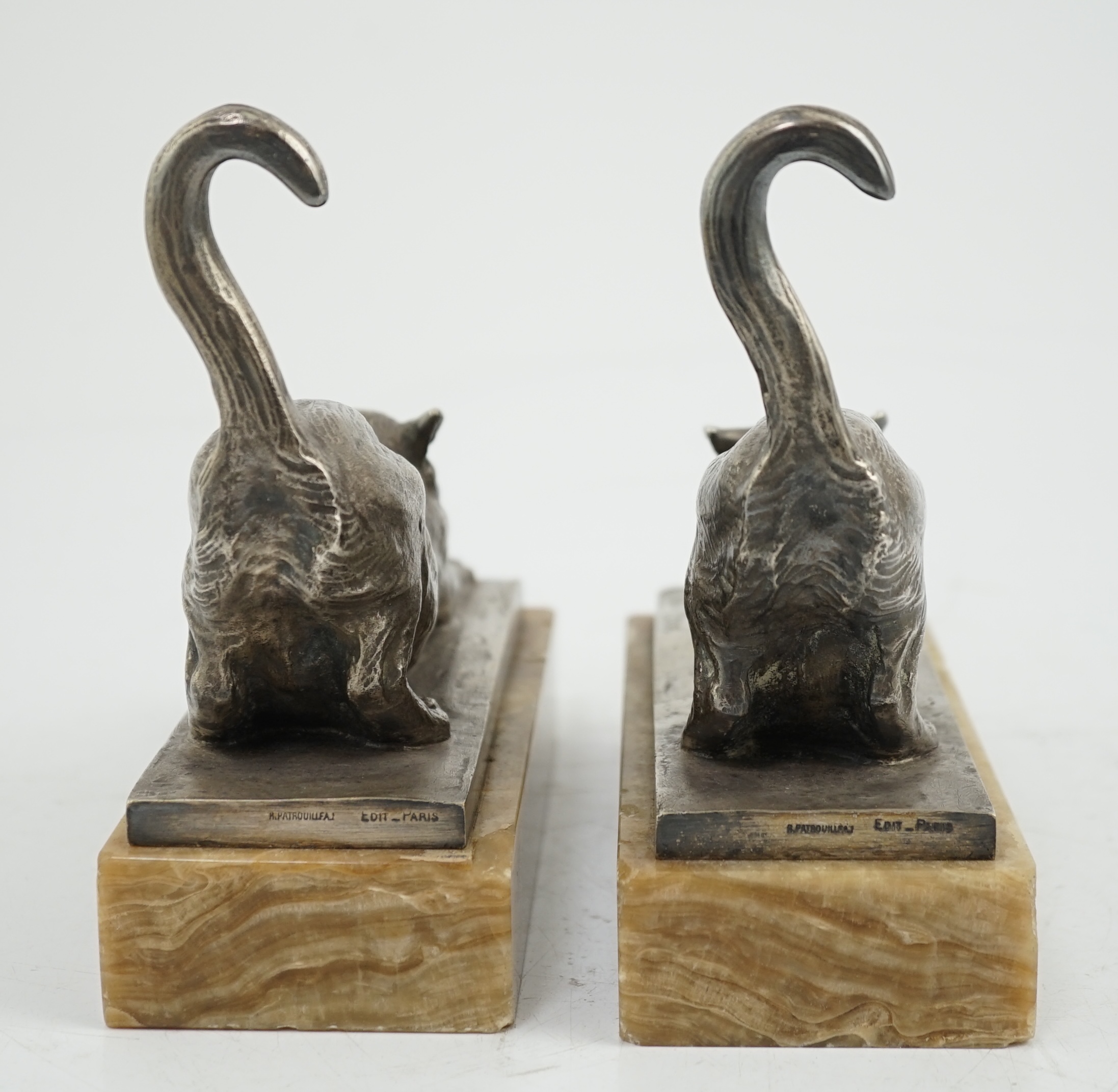 Louis Riché (French, 1877-1949), a pair of silvered bronze bookends modelled as stretching cats